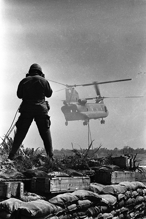 Incoming: A soldier guides a Chinook delivering materials to Fire Support Base Pershing near Dau Tieng