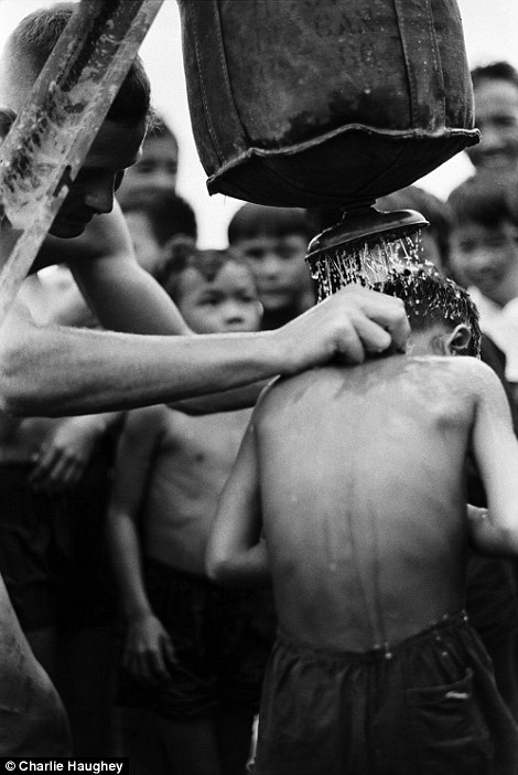 Relief: A medic gives Vietnamese children a shower using a Lyster Bag