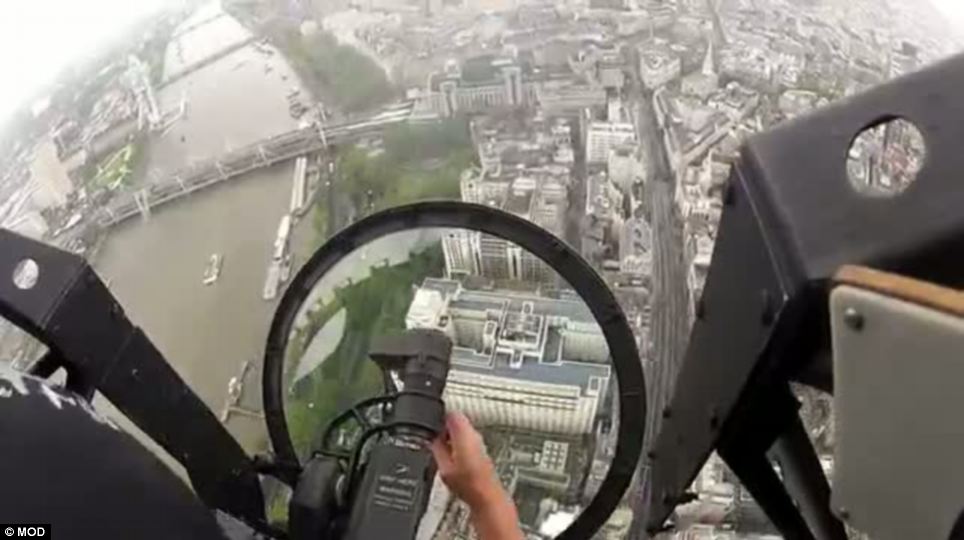 Final approach: The RAF Battle of Britain Memorial Flight Lancaster lines up alongside the Thames with Charing Cross Station ahead of it in the final moments before it flies over the Mall